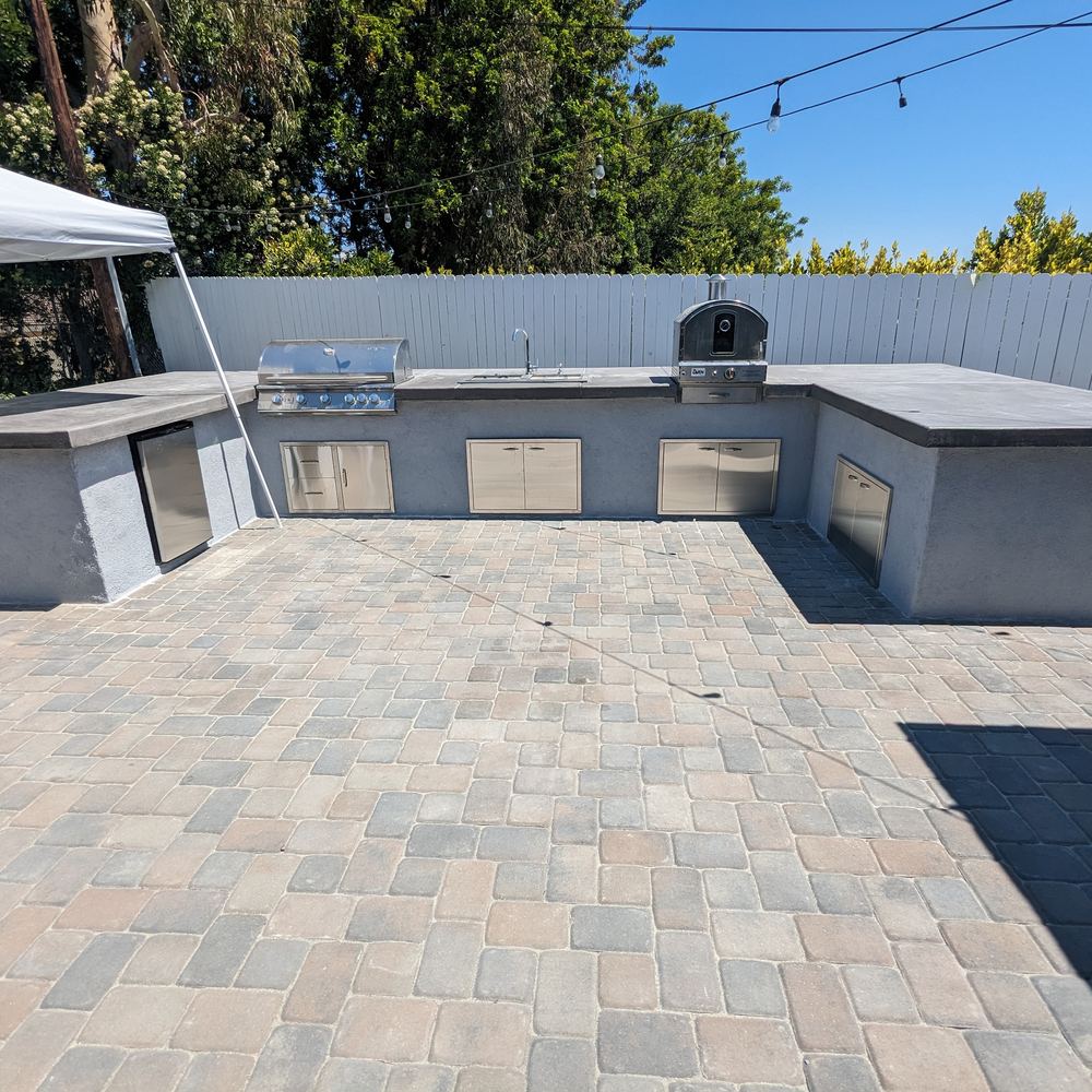 New paver patio along the back of a house