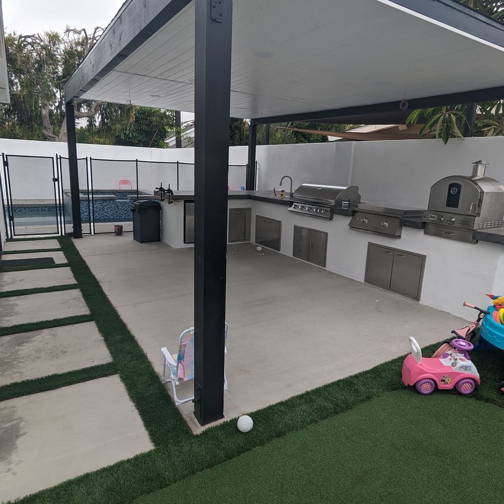 Turf with concrete stepping pads leading to a covered patio